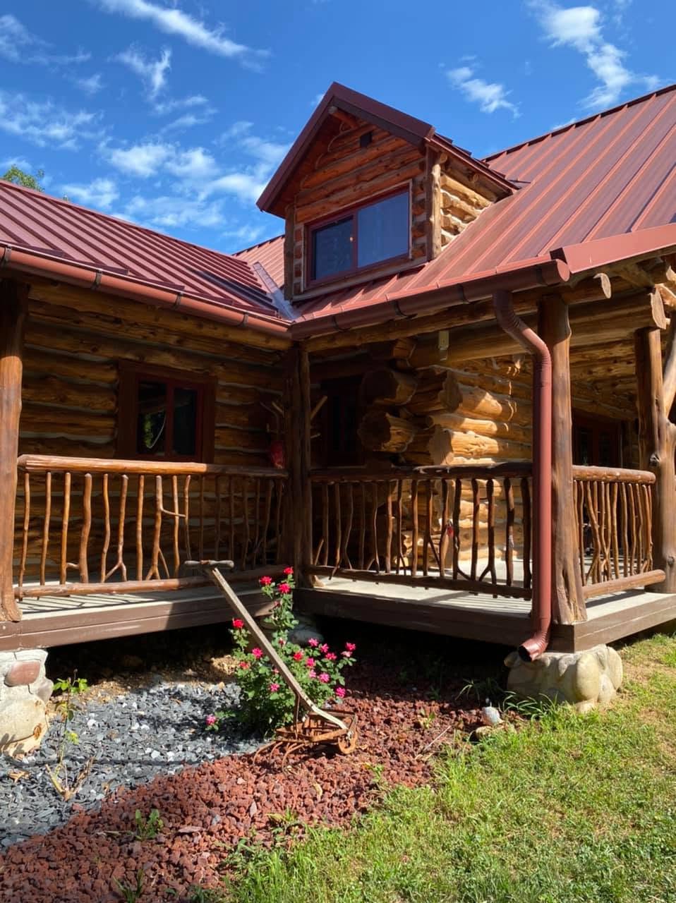 Two-story log home with wrap porch