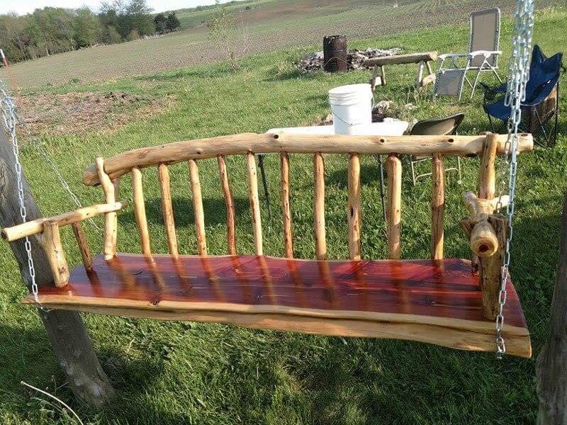 Cedar log porch swing in a yard