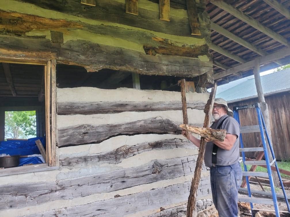 Crane-assisted lift during historic cabin restoration