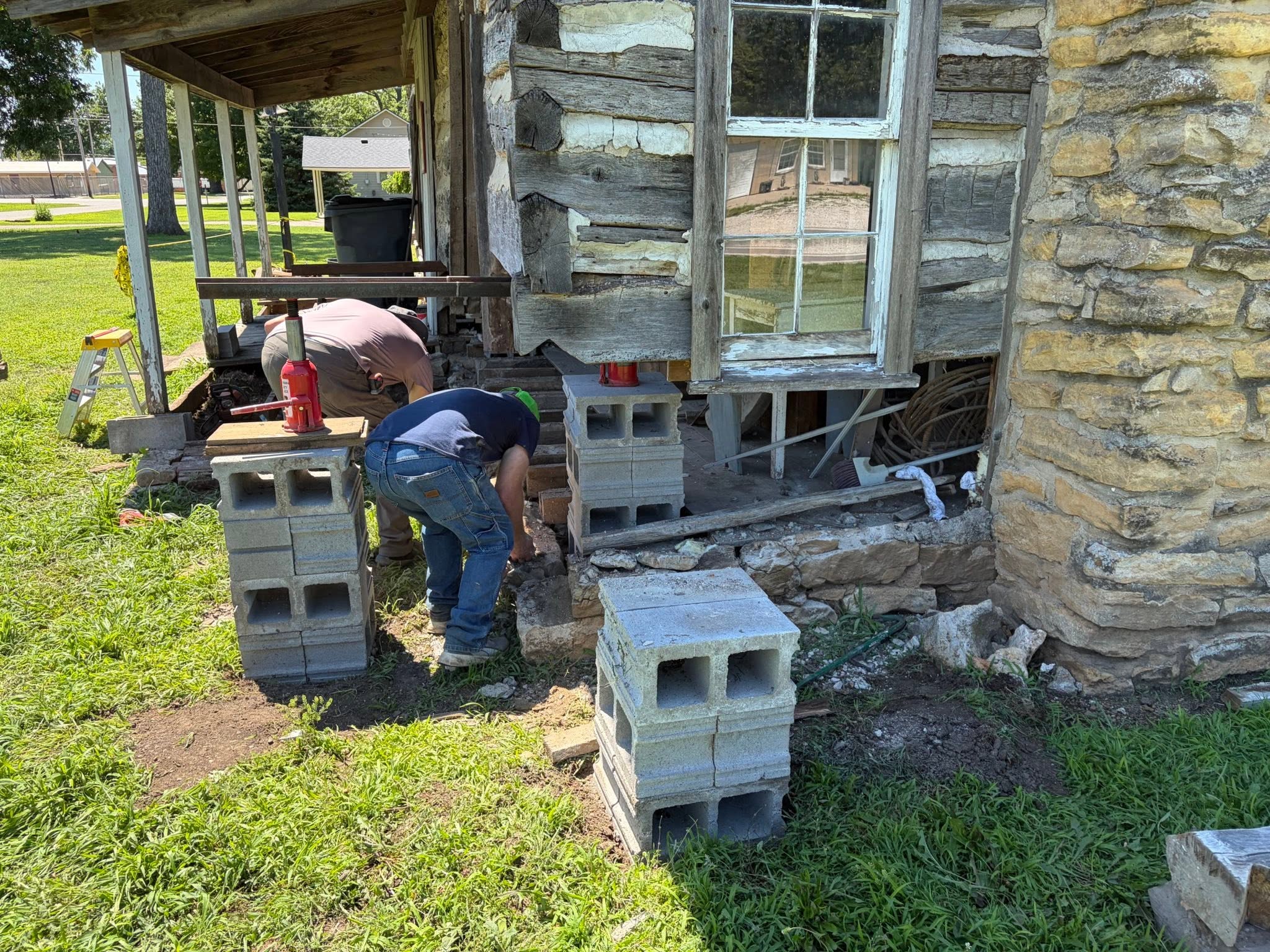 Survey equipment used to level a historic structure during sill replacement